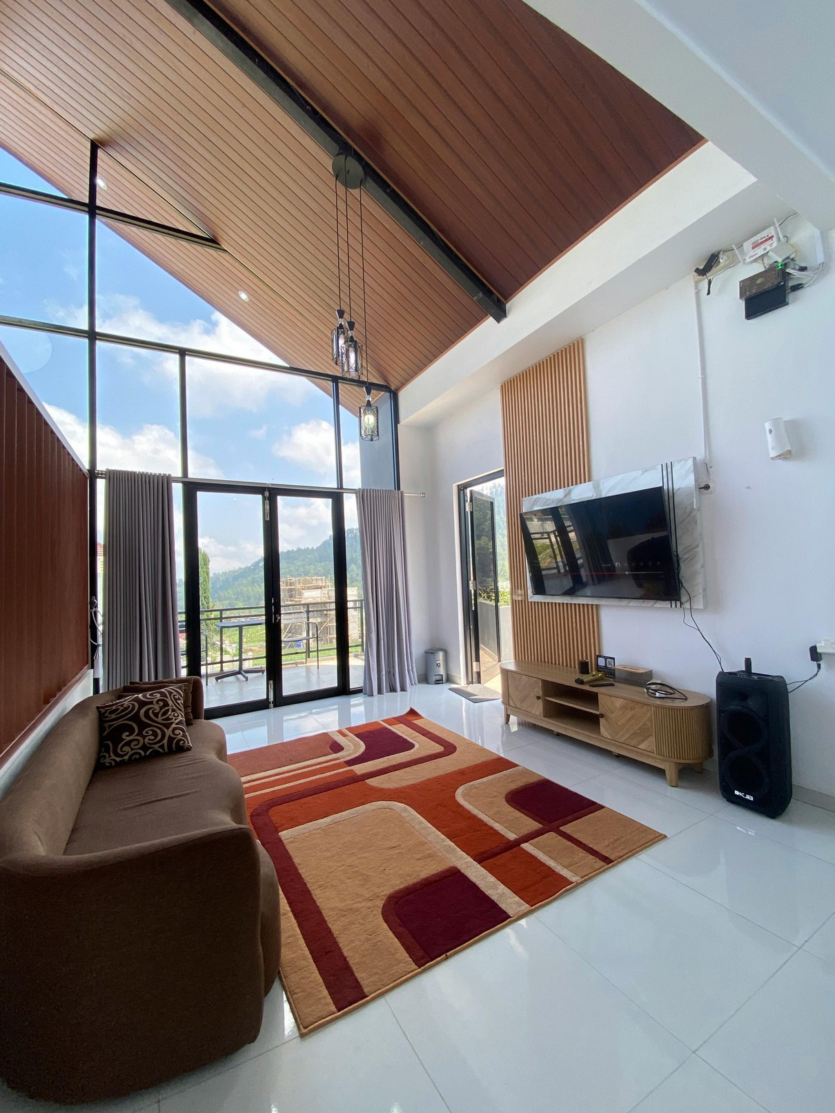 Residential living area with large windows and warm natural light